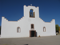 A white building close to a road.