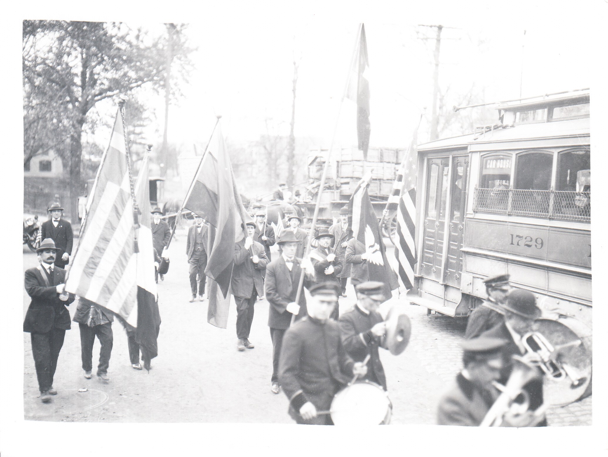 Liberty Bond marchers near streetcar during parade.