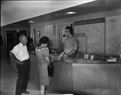 Student Conservation Association (SCA) volunteer Mike Prescott at Visitor Center information desk.