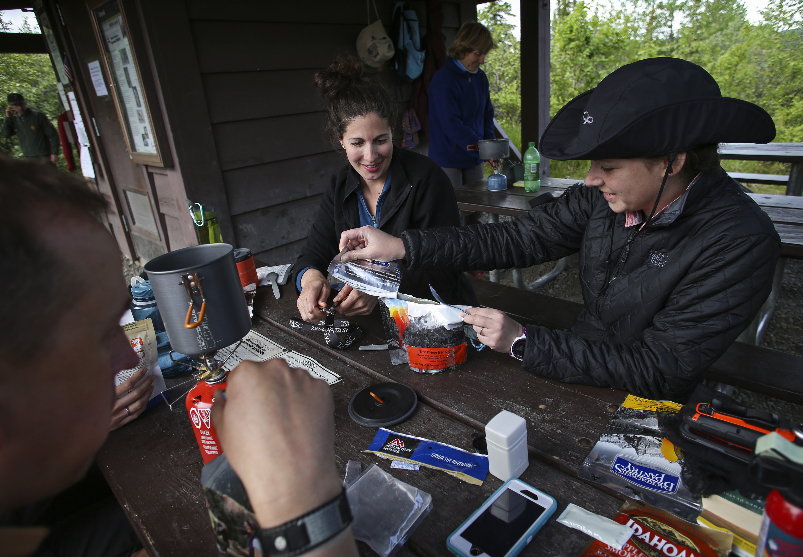 people at a picnic table eating