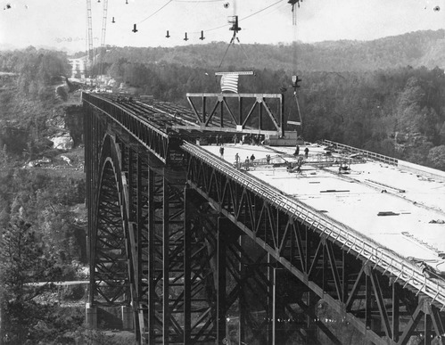 Overhead cable carrying center arch truss