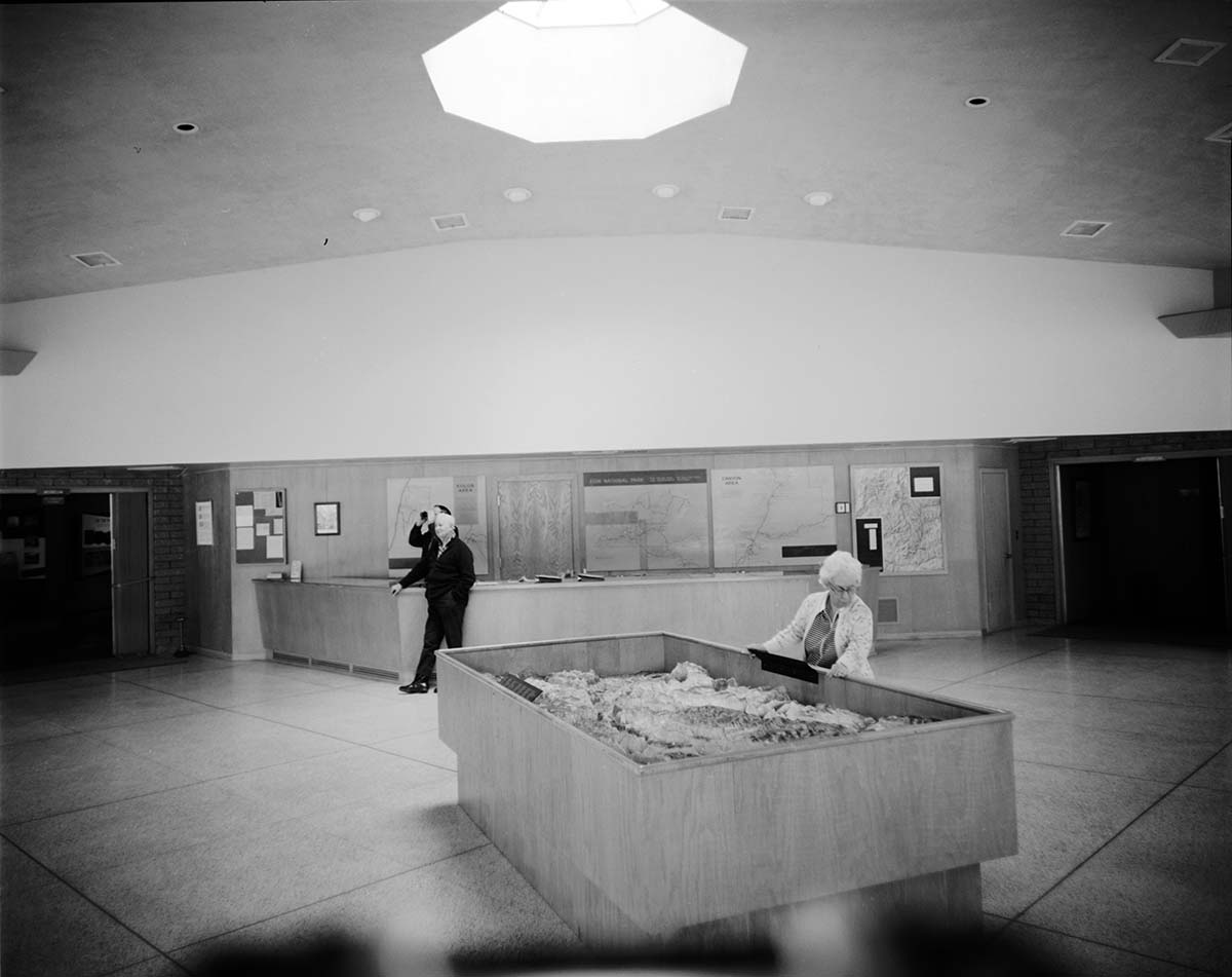 Visitors viewing the interpretive display in the old Mission 66 Visitor Center and Museum.