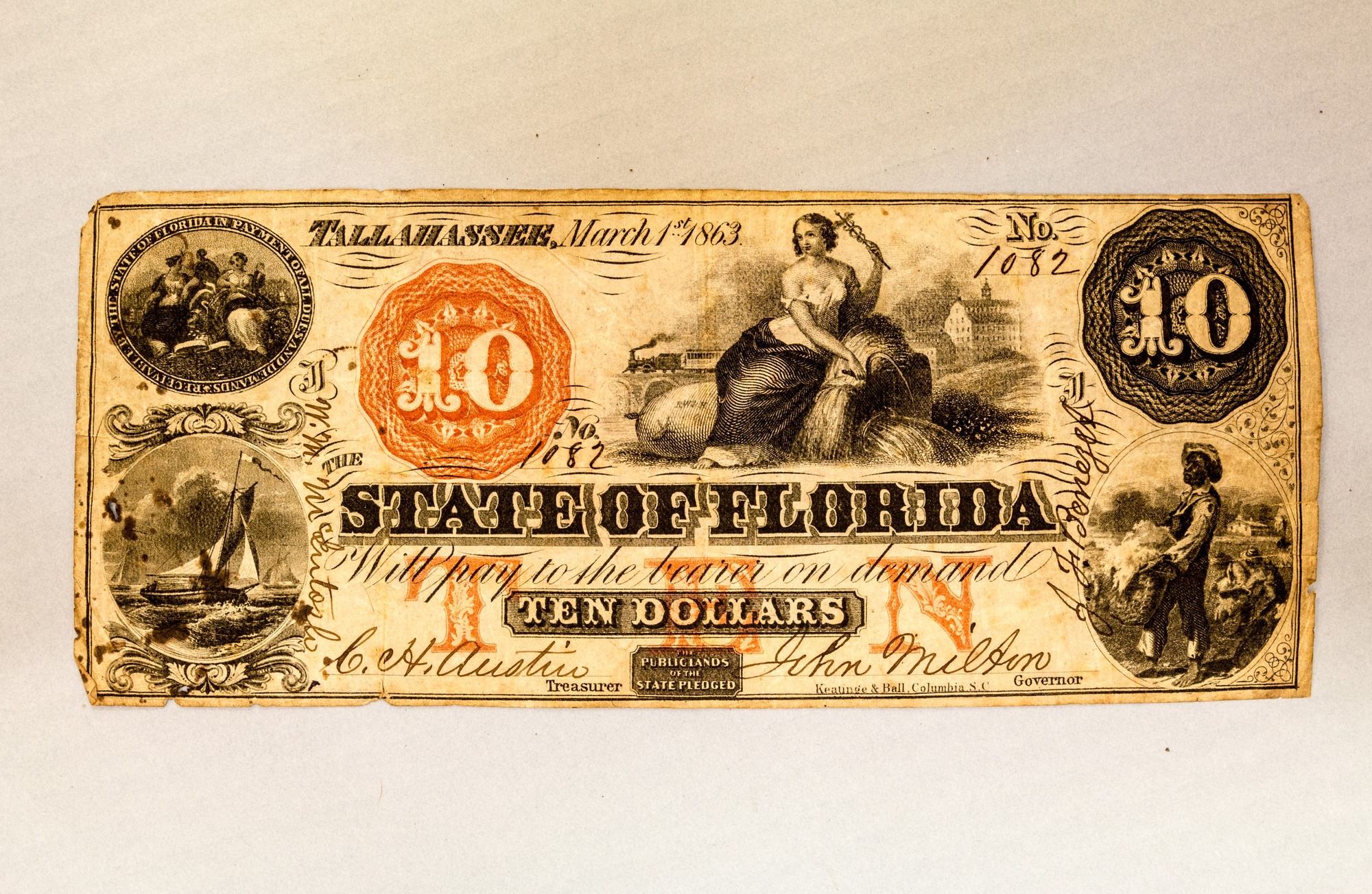 A yellowed bill bearing several illustrations, the number 10, the words "Tallahasee, March 1st, 1862," "The State of Florida will pay to the bearer on demand Ten Dollars," and two cursive signatures. 