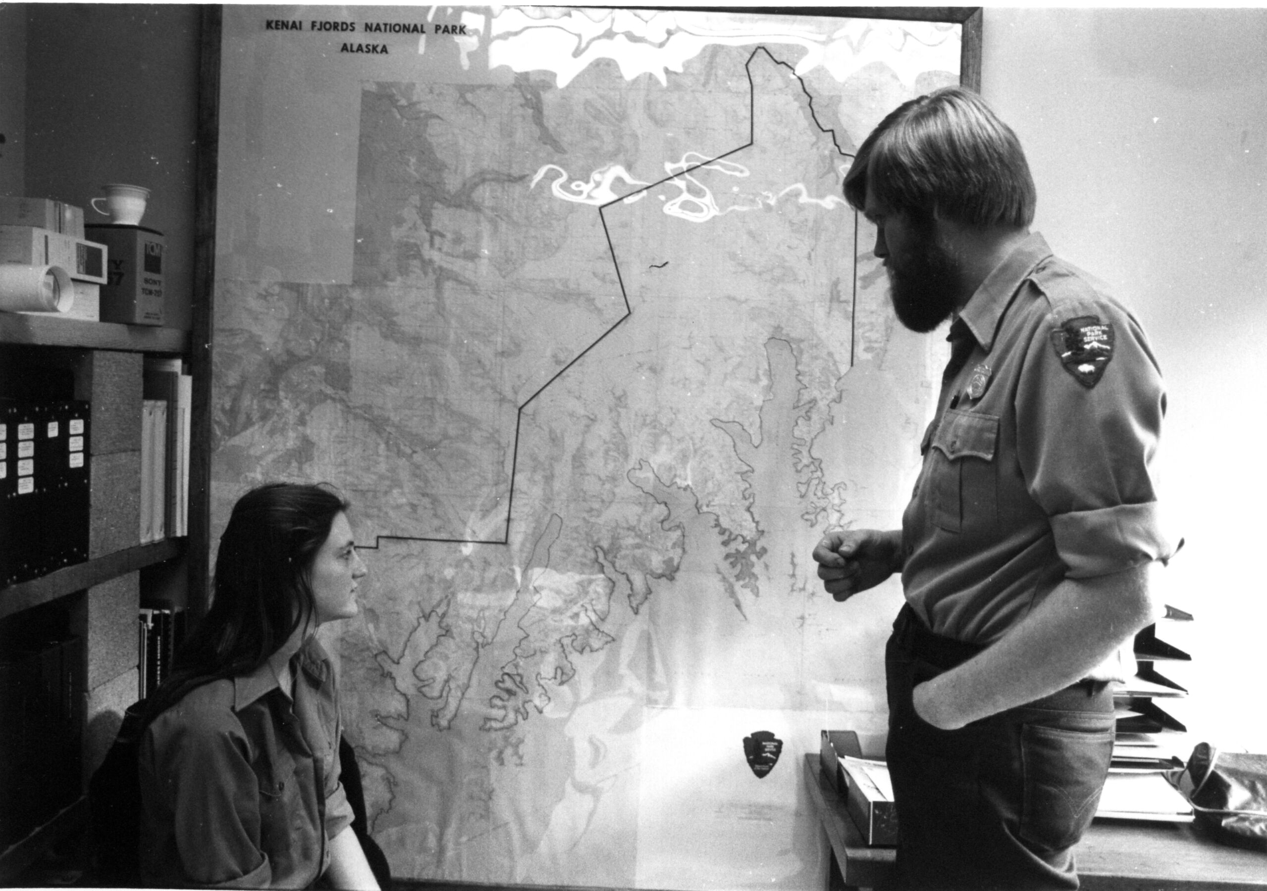 Deb Sturdevant and John Morris check out the map of Kenai Fjords National Park in 1981