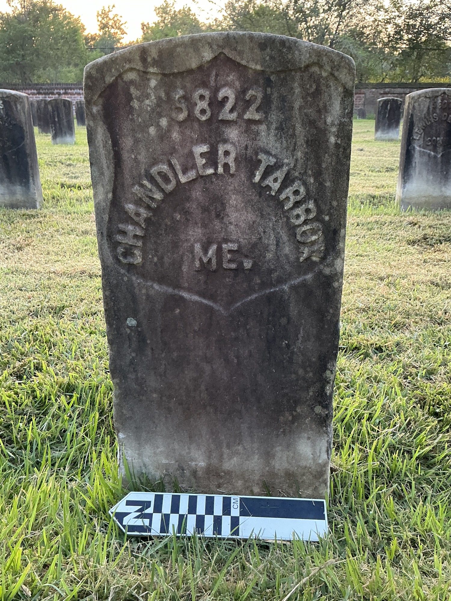 Extra image of historic upright marble headstone with recessed shield face.