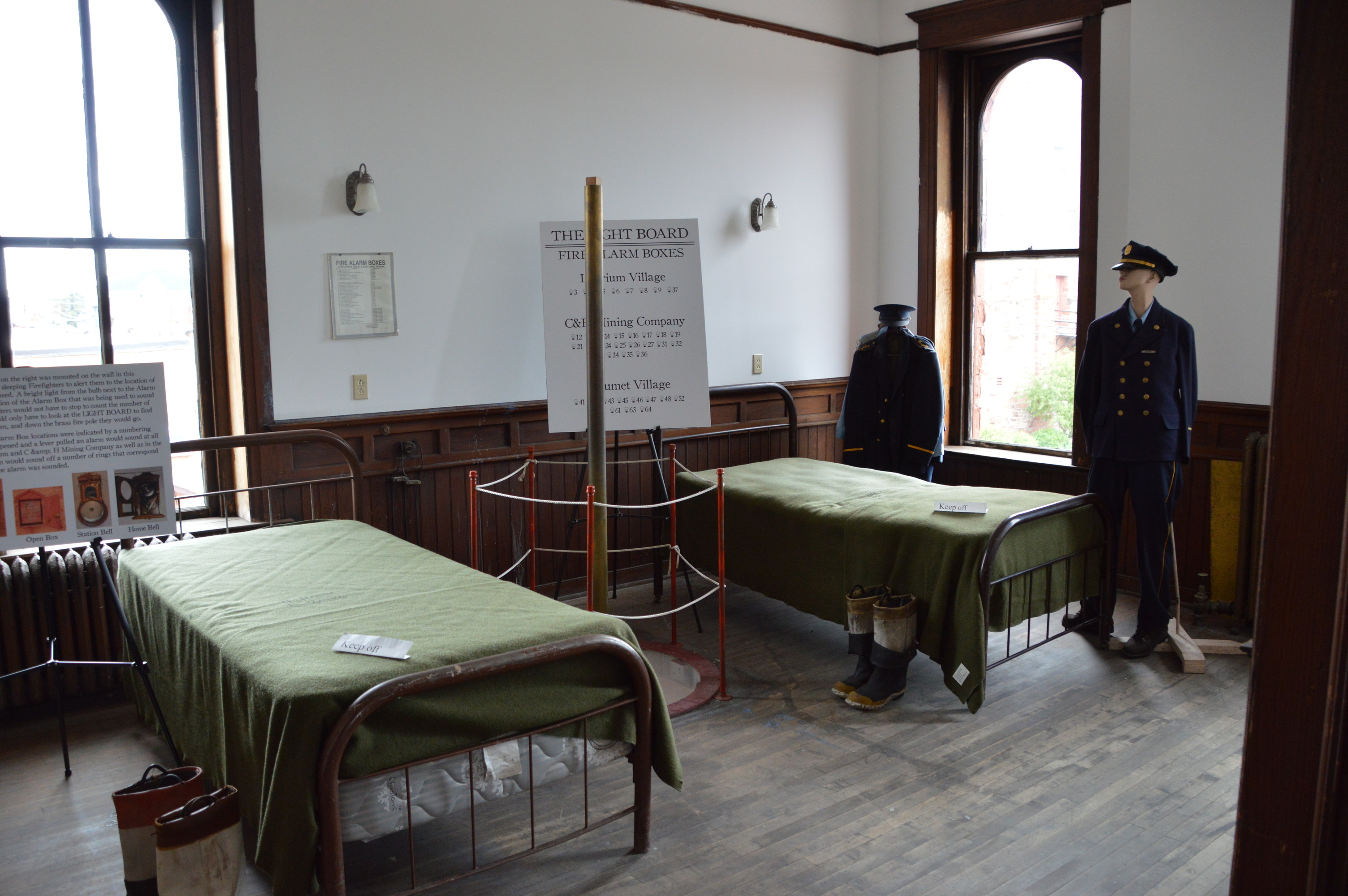 Two beds where firefighters stayed in the fire station. They had small beds and a firepole was nearby in case there was a fire. 