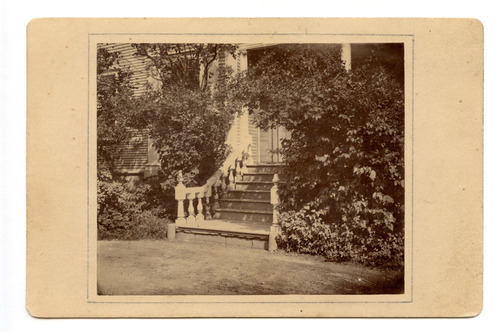 Black and white photograph of staircase mounted on tan backing board.