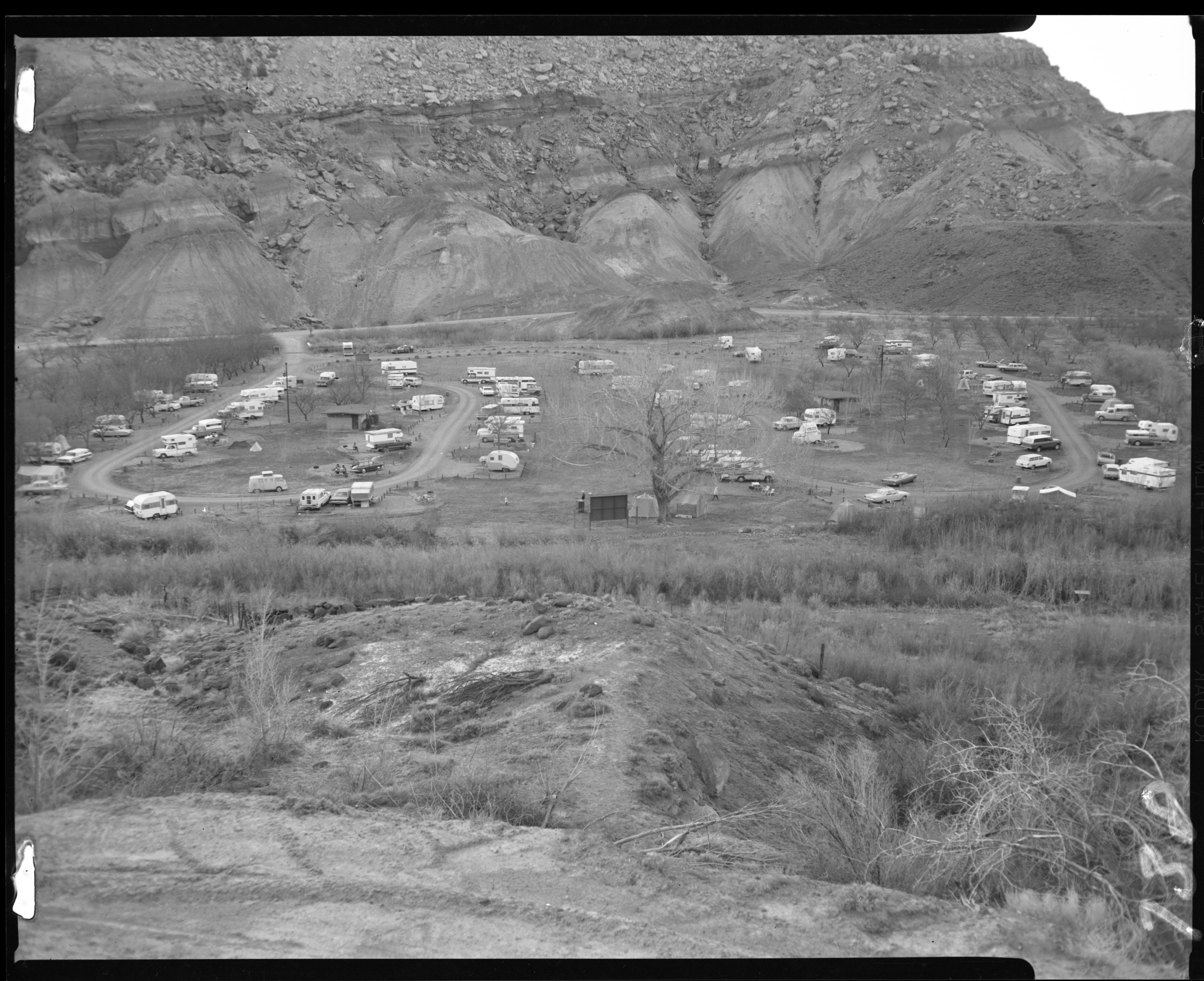 Two campground loops with many trailers and cars parked along side. 