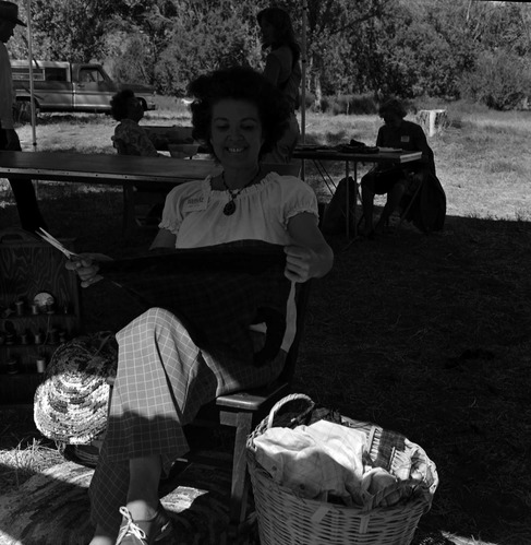 Nancy Wilson cuts materials for braided rag rugs at the second annual Folklife Festival, Zion National Park Nature Center, September 7-8, 1978.