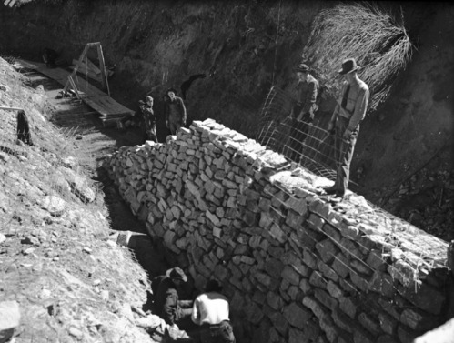 Zion Civilian Conservation Corps (CCC) workers constructing a stone revetment on Oak Creek near the NPS utility area.