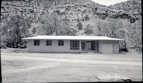 Front view of residence Building 6 in Oak Creek residential area. Lawn and planting in foreground.