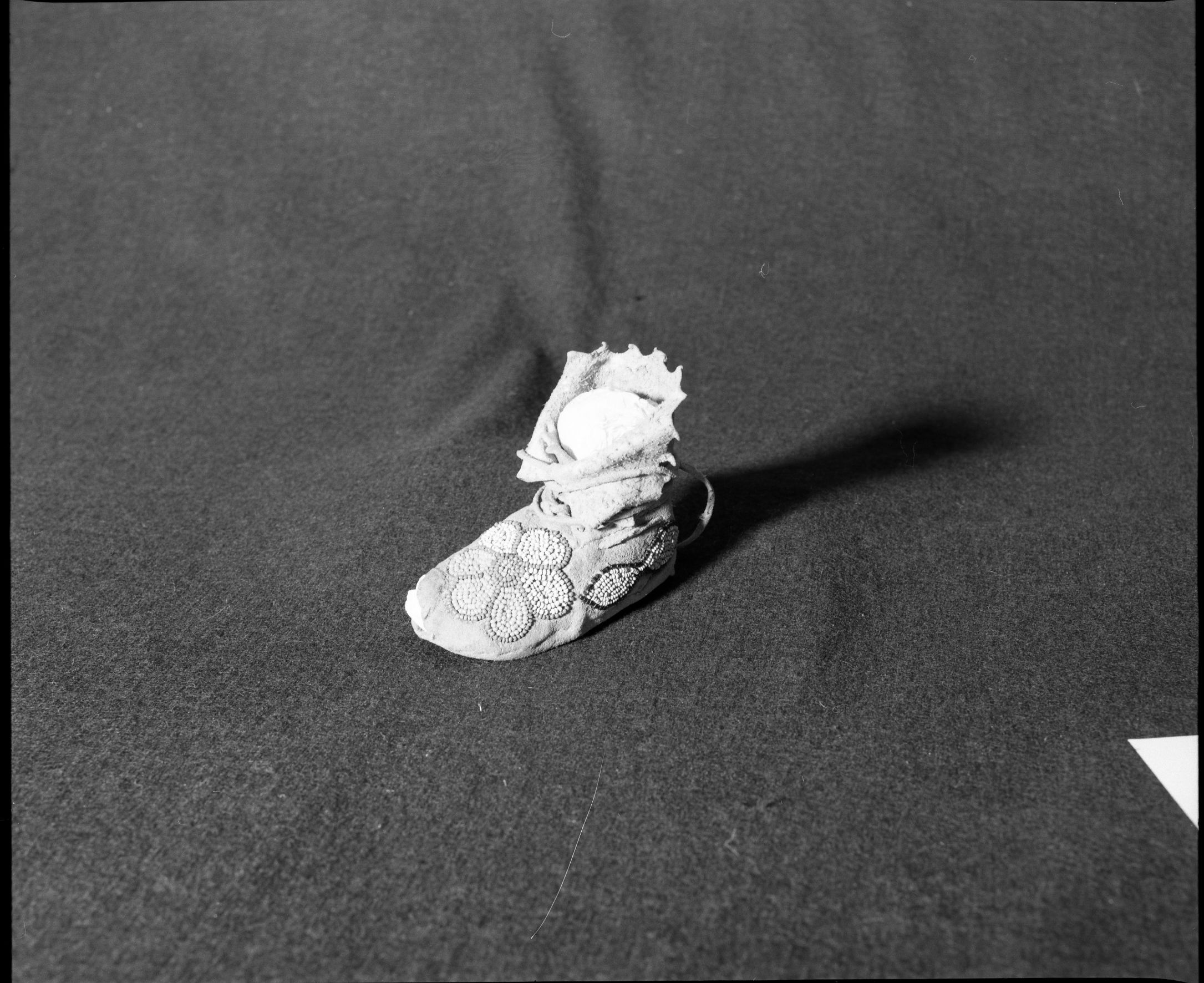 Marie Rozier Collection. Object: Flathead moccasin. Dimensions: 5". Materials: brain-tanned hide, thread, glass beads. Collection History: Made ca. 1910. Photographed by Michael Dixon, December 1982. Catalogued by Craig Bates and Barbara Beroza. Yosemite Collections, National Park Service.