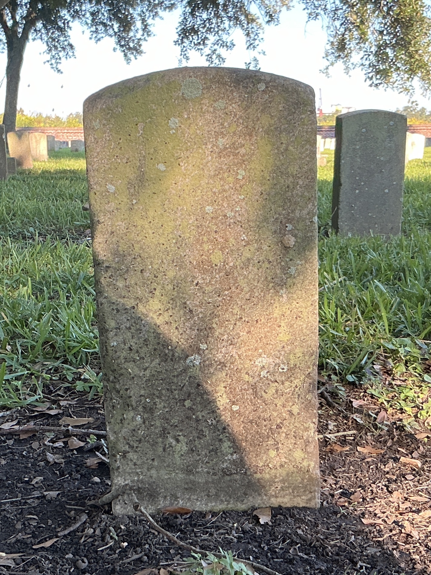 Back of historic upright marble headstone