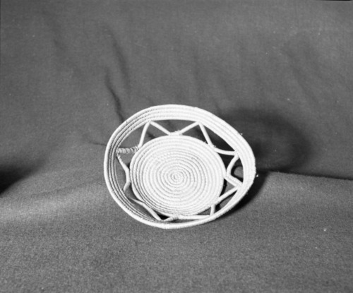 Marie Rozier Collection, Catalog No. 6. Object: basketry plaque. Dimensions: 9 1/2 x 2". Materials: unidentified. Technology: rightward coil direction, inside work face, split stitch. Collection History: Uncertain origin. Alice Reade Collection. Photographed by Michael Dixon, December 1982. Catalogued by Craig Bates and Barbara Beroza. Yosemite Collections, National Park Service.