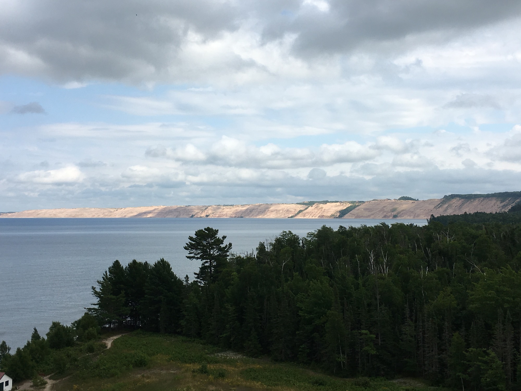 Au Sable Lighthouse View of Lake Superior and the Grand Sable Dunes. The Au Sable Lighthouse was built here because of the dangers to navigation. Shallow water extends almost two miles out into Lake Superior and creates a risk to ships. The Grand Sable Dunes and Lake Superior combine to create quickly forming fog banks that also pose a risk to navigation. 