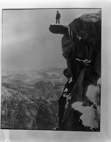 Galen Clark on overhanging rock, Glacier Point, Yosemite