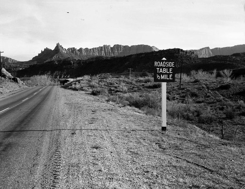 Authorized signs on road through Springdale: highway info sign and Grandma's signs.