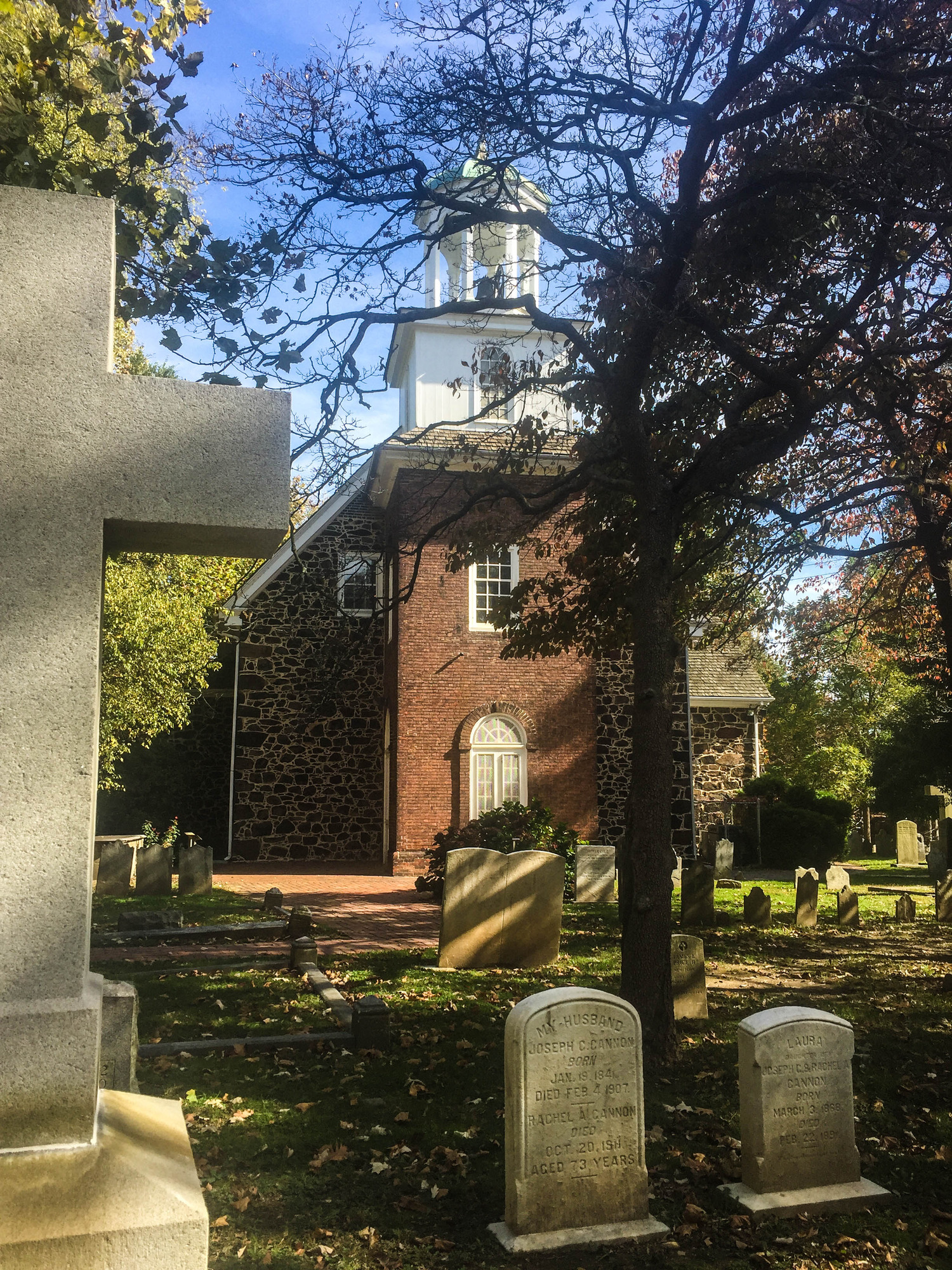 Brick church surrounded by a churchyard cemetery 