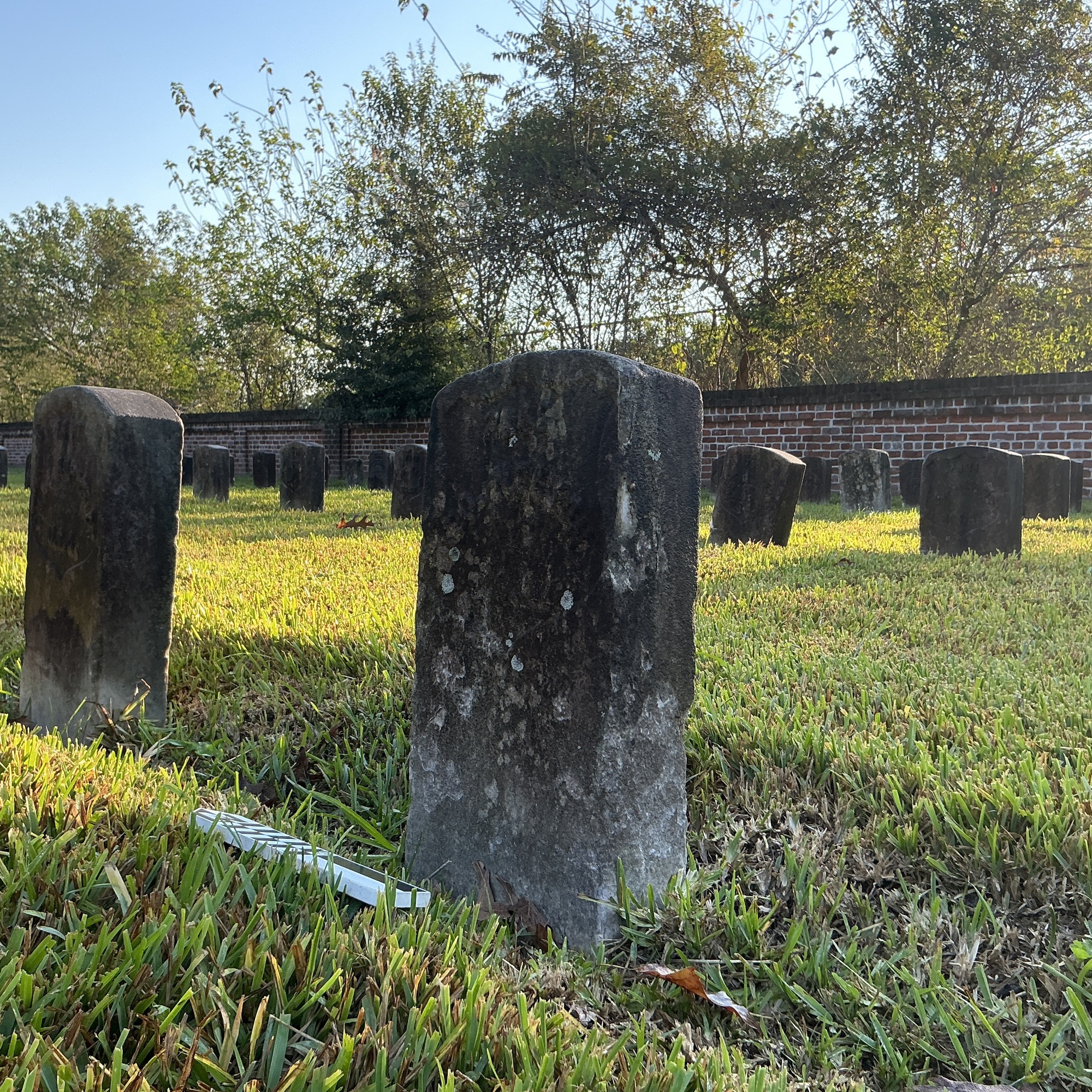 Extra image of historic upright marble headstone with recessed shield face.