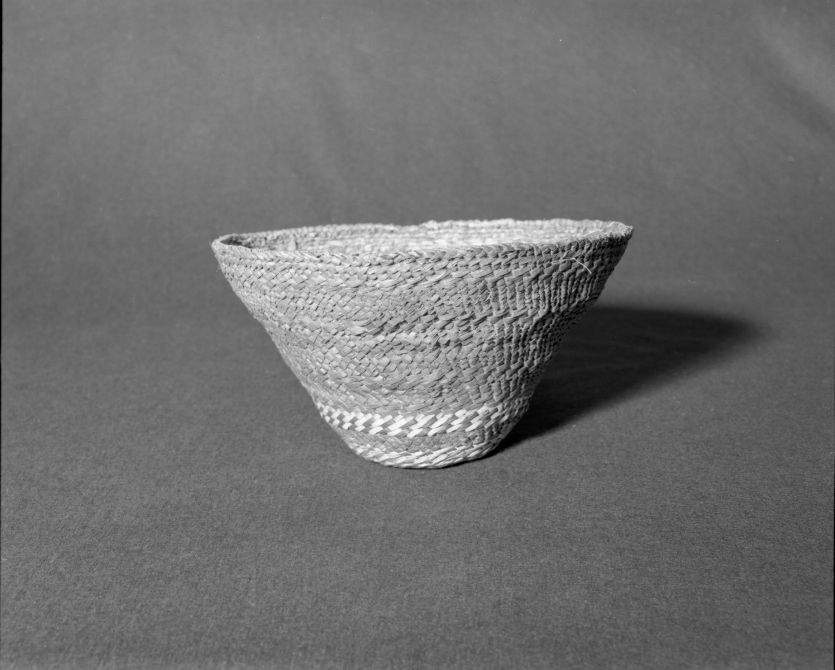 Marie Rozier Collection, Catalog No. 2-CAN-1. Object: Nootka hat. Dimensions: 11 x 6 1/2". Materials: red cedar bark, grass. Technology: Up to right slant of turns, inner ring to fit head. Collection History: Purchased on Vancouver Island in 1969 for $35. Photographed by Michael Dixon in December 1982. Catalogued by Craig Bates and Barbara Beroza. Yosemite Collections, National Park Service.