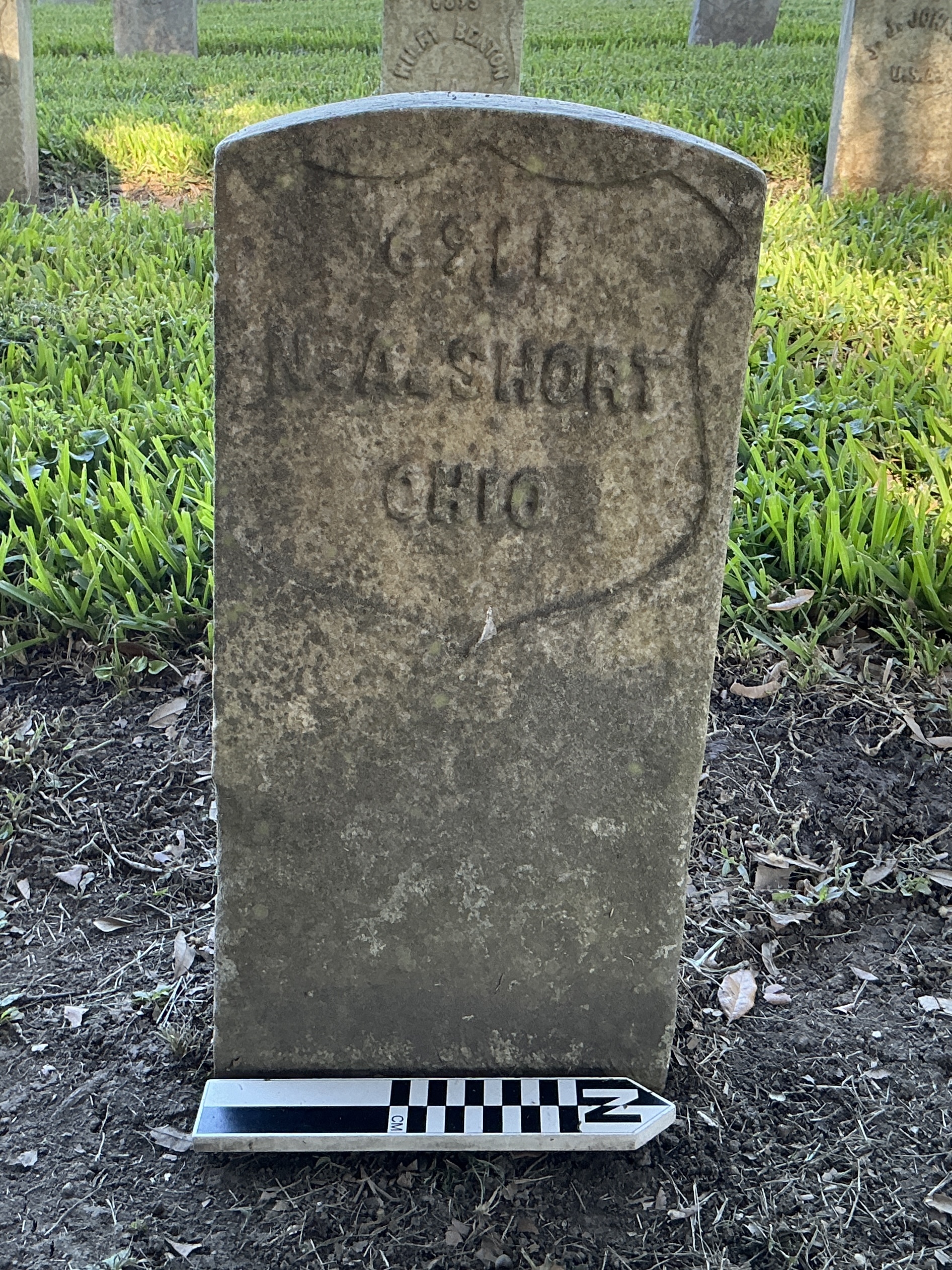 Extra image of historic upright marble headstone with recessed shield face.