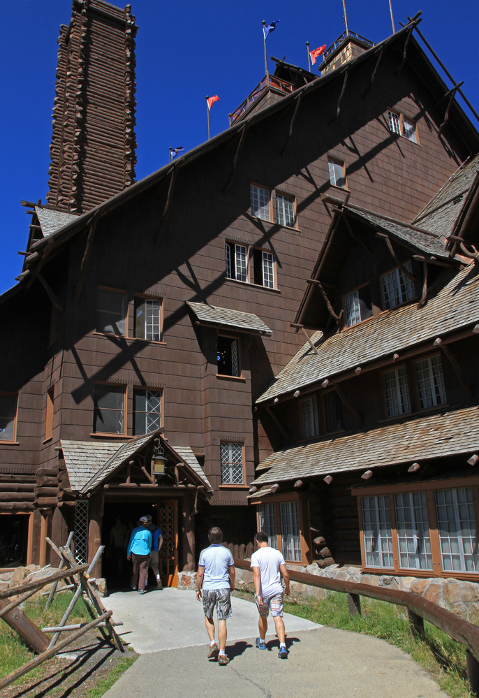 Two people entering back door of Old Faithful Inn