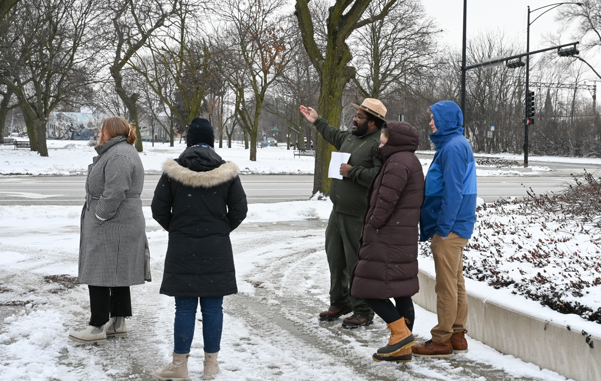 A ranger giving a group of visitors a tour in the snow.