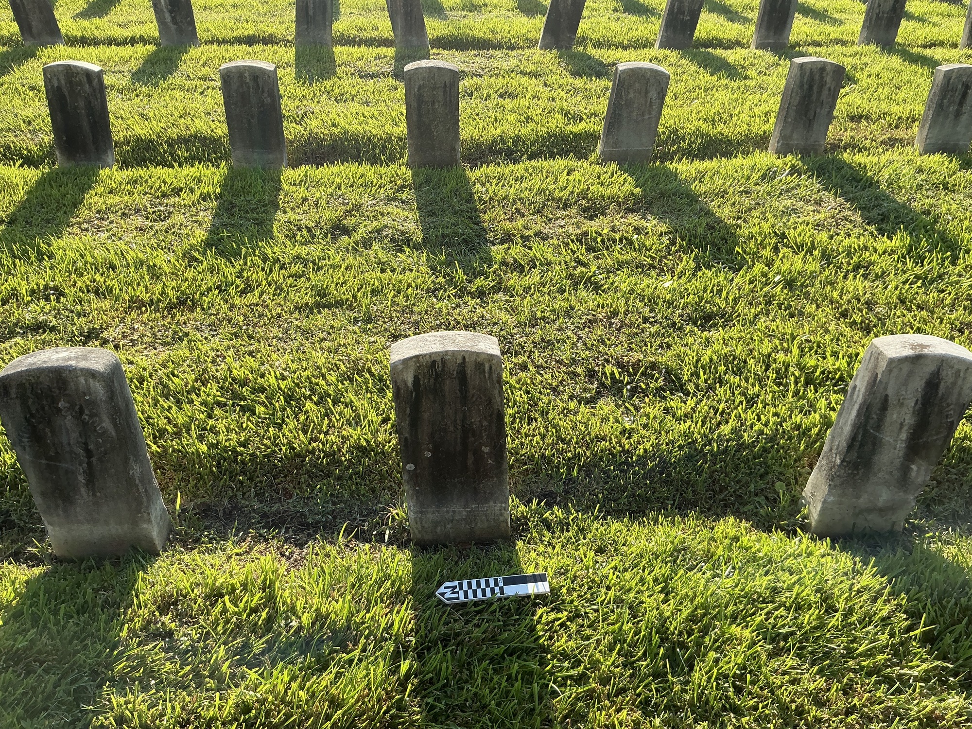 Extra image of historic upright marble headstone with recessed shield face.