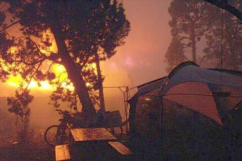 Night photos of a house burning during the Long Mesa fire in Mesa Verde National Park, July-August 2002