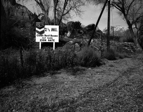 Roadside signs in Springdale. Utah Parks Company sign for Standard Stations, Inc. service station. 'Clean restrooms just inside Zion gate.'