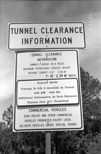 Close up of 'Tunnel Clearance Information' sign during construction of headquarters addition.