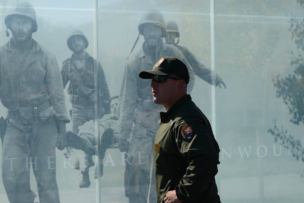 A park ranger stands in front of the American Veterans Disabled for Life Memorial