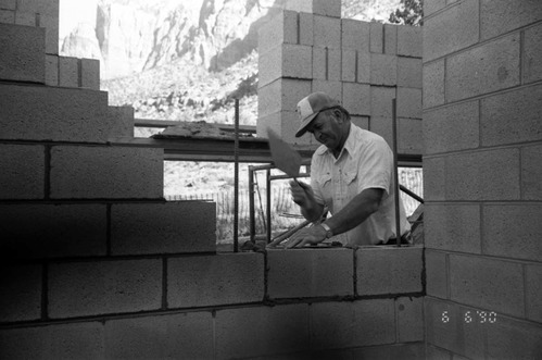 Man worker laying bricks during the construction of headquarters addition.
