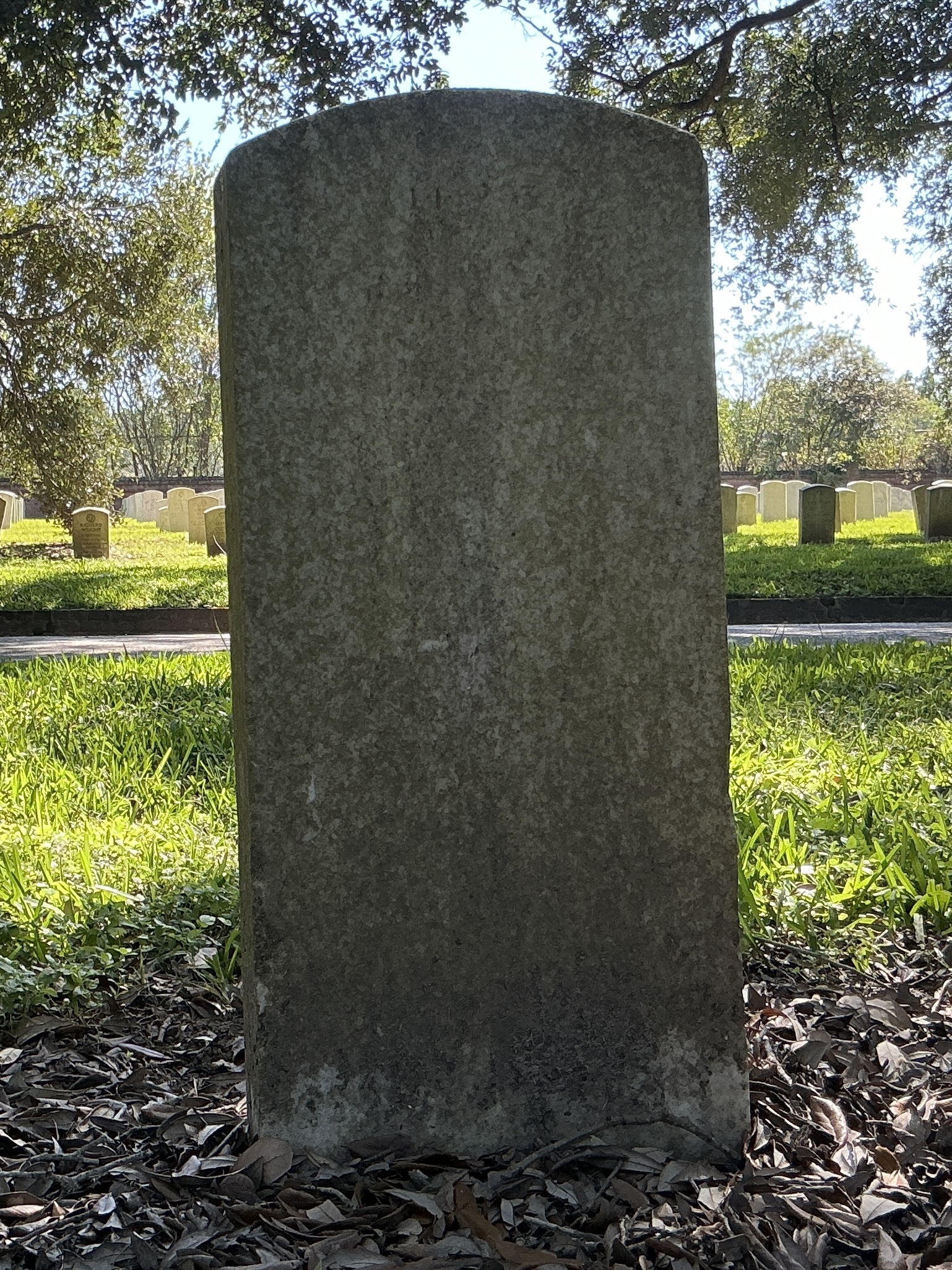Back of upright marble headstone with flat face.