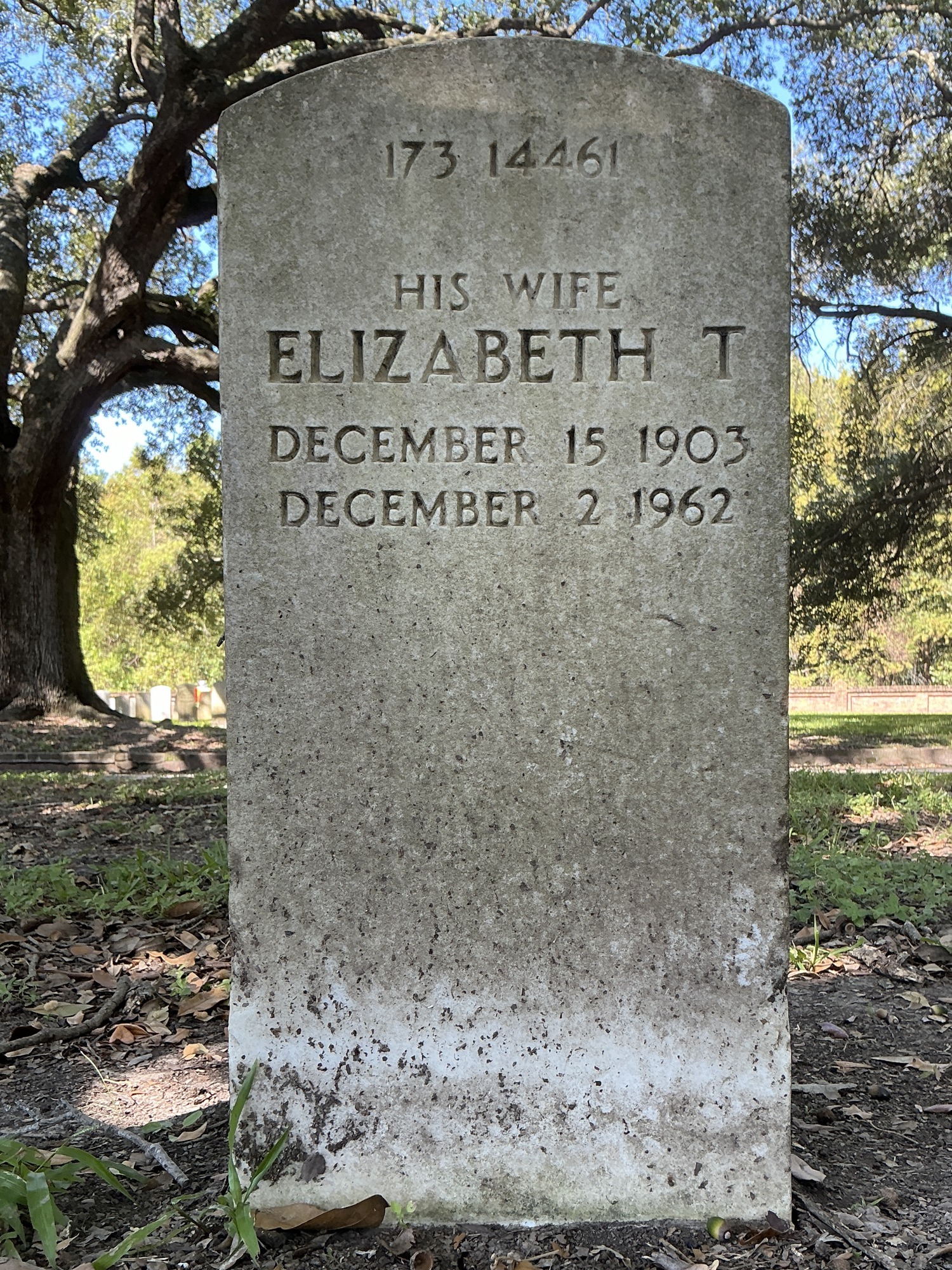 Back of upright marble headstone with flat face.