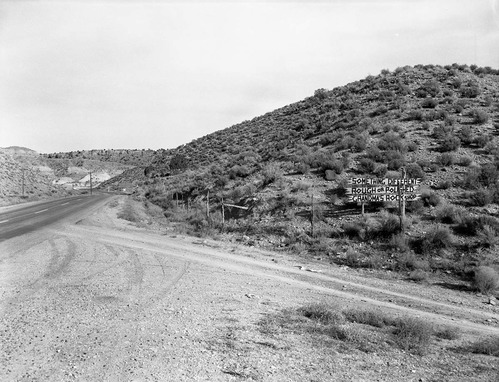 Grandma's signs on State Route 15 (now State Route 9), black on yellow signs at almost every turn from below Virgin, Utah to Zion National Park. This sign was at the west end of Rockville and reads 'Something different rough or polished Grandma's rock shop'. These photos were taken as documentation for the proposed clean up project to remove undesirable signs and debris on the route to Zion National Park.