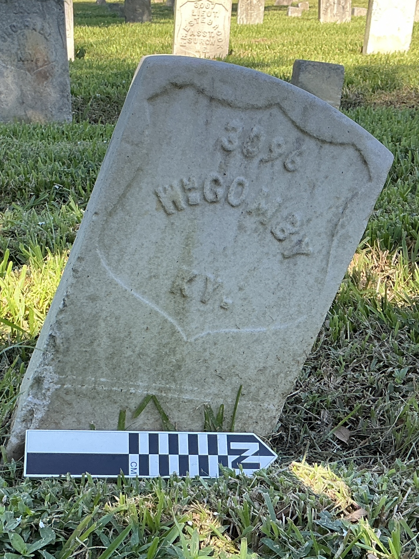 Extra image of historic upright marble headstone with recessed shield face.