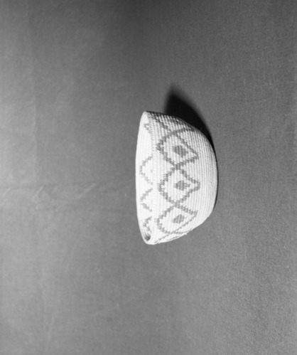 Mrs. Donald Segerstrom Collection. Object: Miwok basket. Dimensions: 8 1/4 x 4 1/4". Materials: split willow, bracken fern root. Technology: leftward coil direction, interlocking stitch, fag ends trimmed on work face or slipped forward, moving ends trimmed on interior, overstitched rim. Photographed by Michael Dixon, January 1983. Catalogued by Craig Bates and Barbara Beroza. Yosemite Collections, National Park Service.