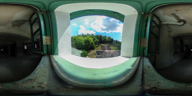 An open window looking out to the stairs that lead to the entrance of the park