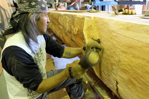 Carver cutting into wood
