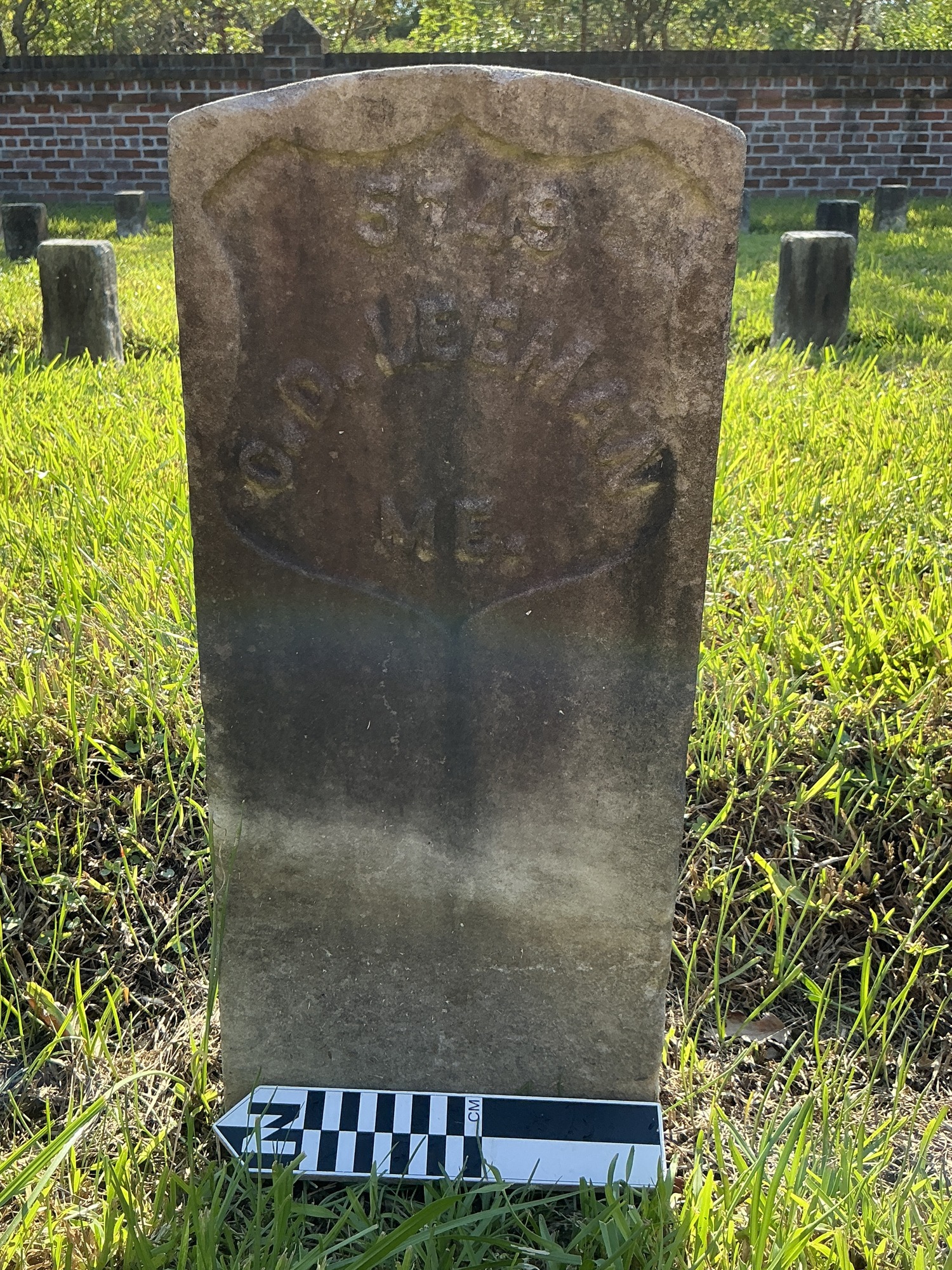 Extra image of historic upright marble headstone with recessed shield face.