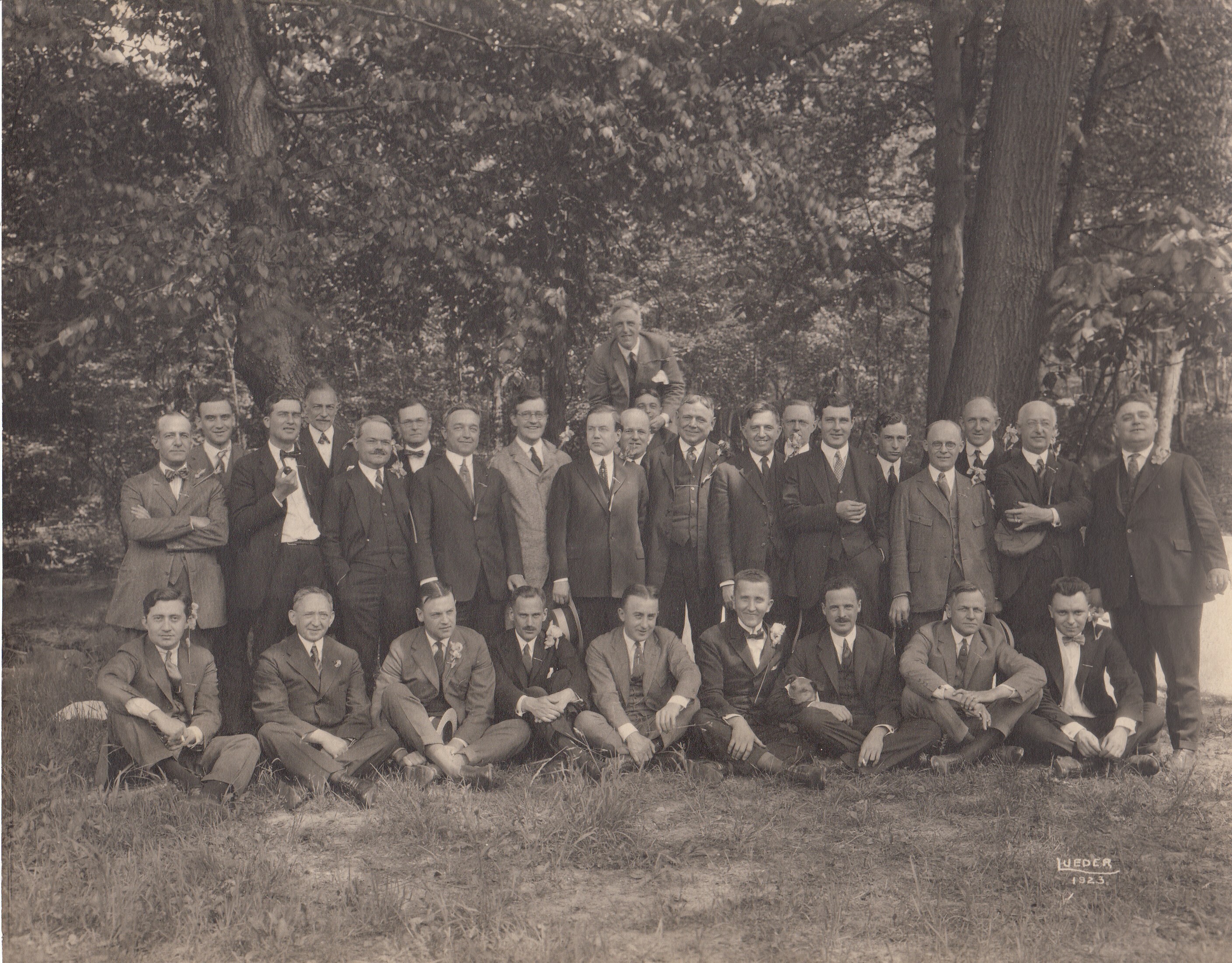 Charles Edison and group of Edison employees wearing flowers.
