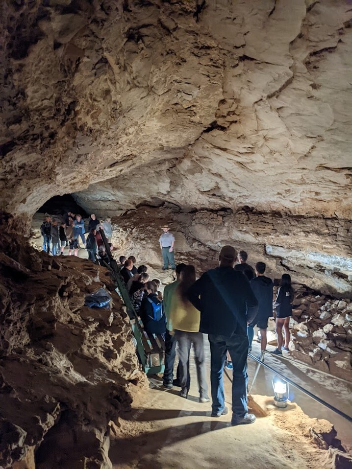Park ranger and visitors inside Mammoth Cave on lantern tour.