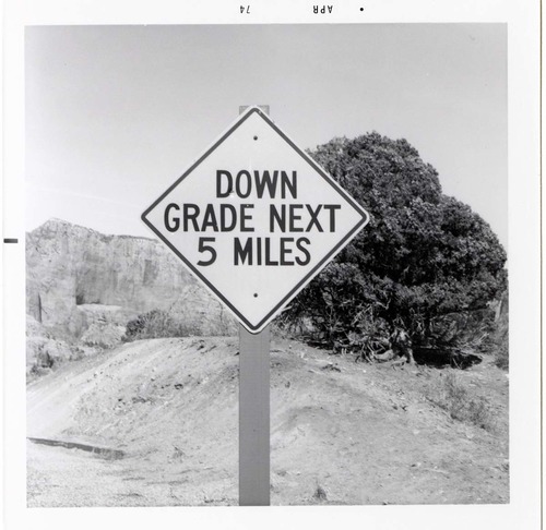 Road sign reading 'Down Grade Next 5 Miles' in Kolob Canyon.