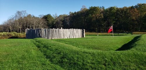 Round stockade an redoubt (earthworks) with red British ensign