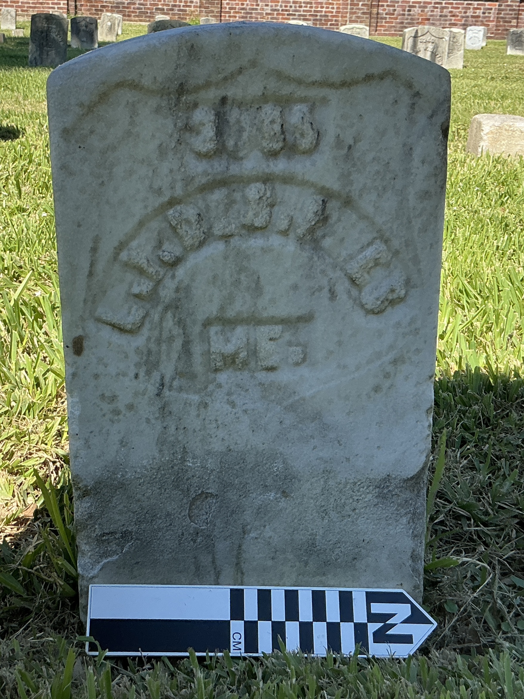 Extra image of historic upright marble headstone with recessed shield with recessed lettering face.