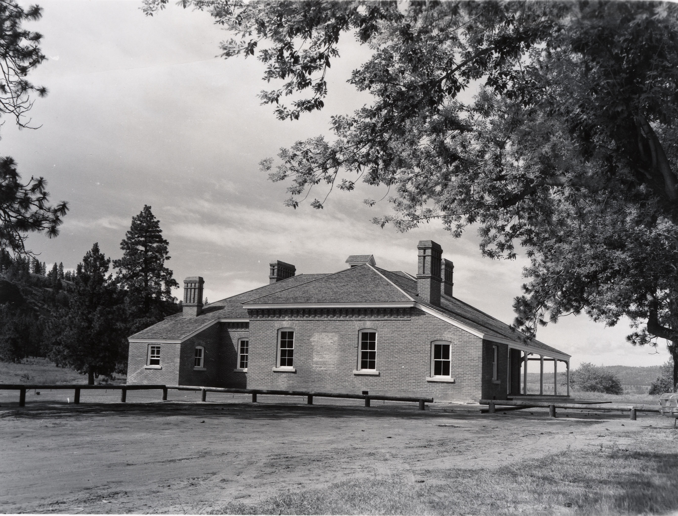 Black and white photograph of a single story brick building.