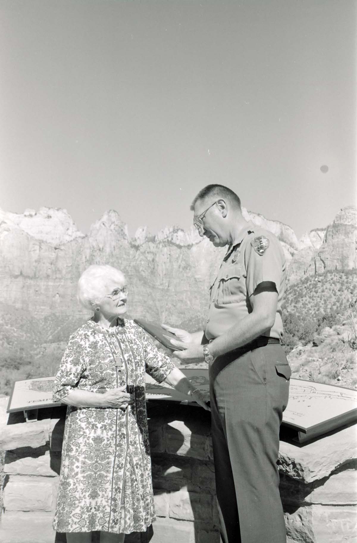 BW Photos of Superintendent Harold Grafe giving award to lady.