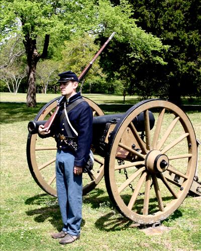 Park ranger in Civil War Union soldier costume poses in Shiloh National Cemetery