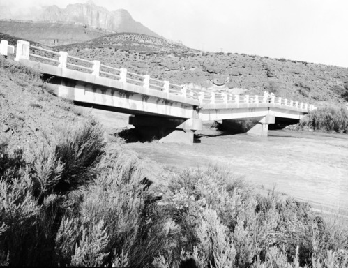 The flooding and the partially collapsed bridge at Coal pits Wash on State Route 15 (now State Route 9). Damage caused by flood waters from the 'Great Flood of September' (September 17, 1961) which also claimed the lives of 5 people in the Narrows. [See ZION 8600, 8599, 8598]